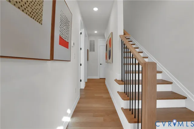 a view of a hallway with wooden floor and entryway
