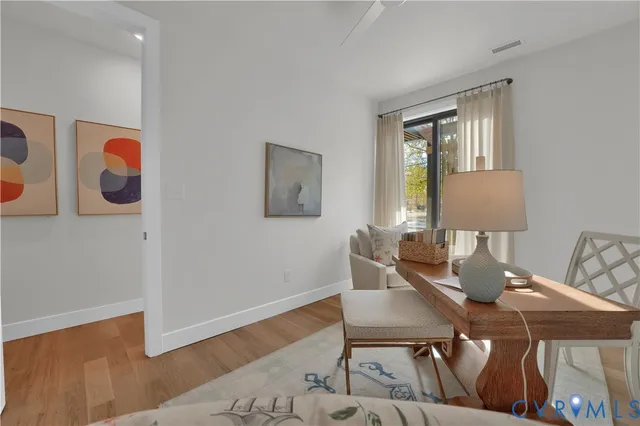 a view of a dining room with furniture and wooden floor
