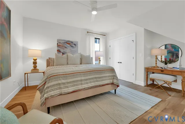 a bedroom with a bed and wooden floor