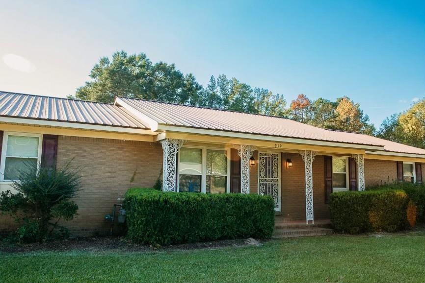 457 Maple Circle Hickory Flat, MS 38633 - Photo 23 of 24 a view of a house with brick walls and a yard with plants