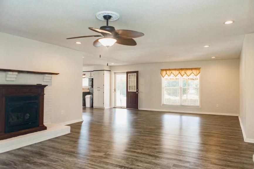 457 Maple Circle Hickory Flat, MS 38633 - Photo 3 of 24 a view of an empty room with wooden floor fireplace and a window