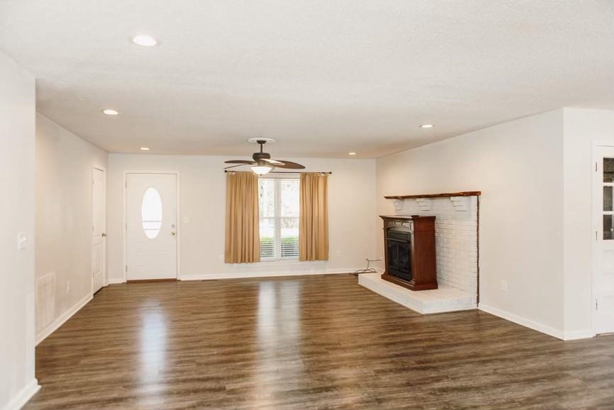 457 Maple Circle Hickory Flat, MS 38633 - Photo 5 of 24 a view of an empty room with wooden floor and a window