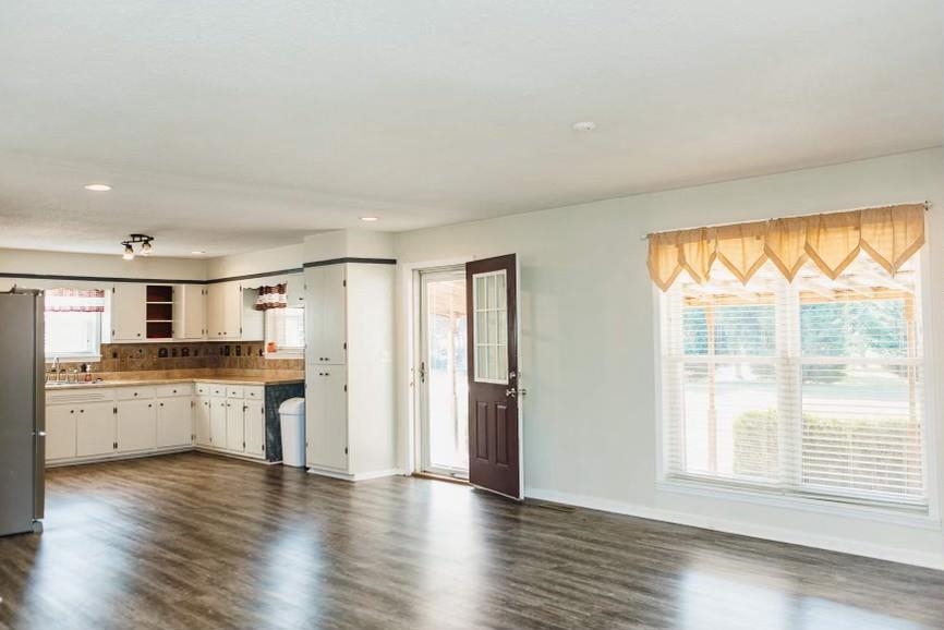 457 Maple Circle Hickory Flat, MS 38633 - Photo 6 of 24 a large kitchen with cabinets wooden floor and a sink