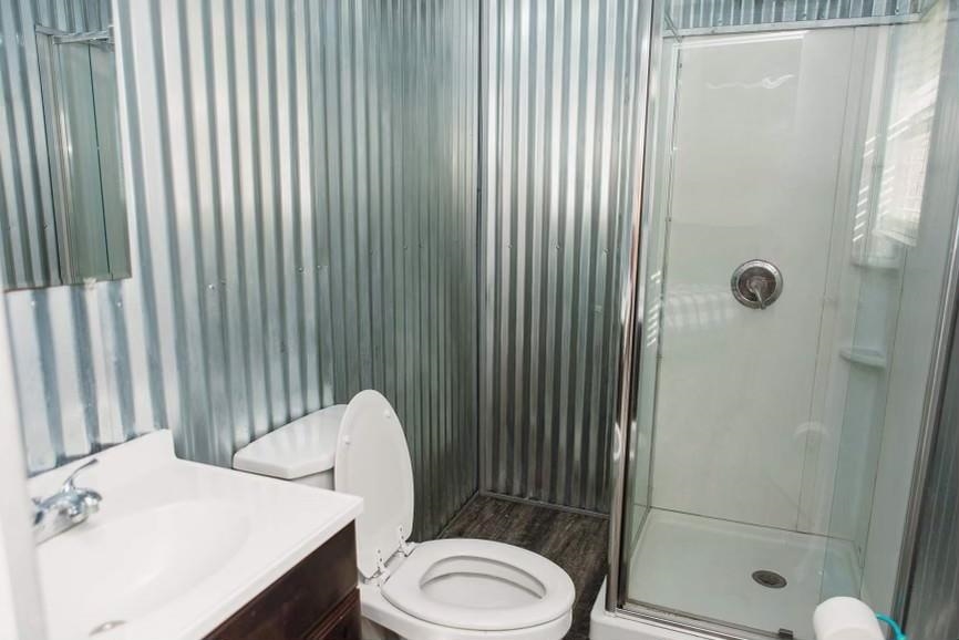 457 Maple Circle Hickory Flat, MS 38633 - Photo 9 of 24 a bathroom with a sink a toilet and shower