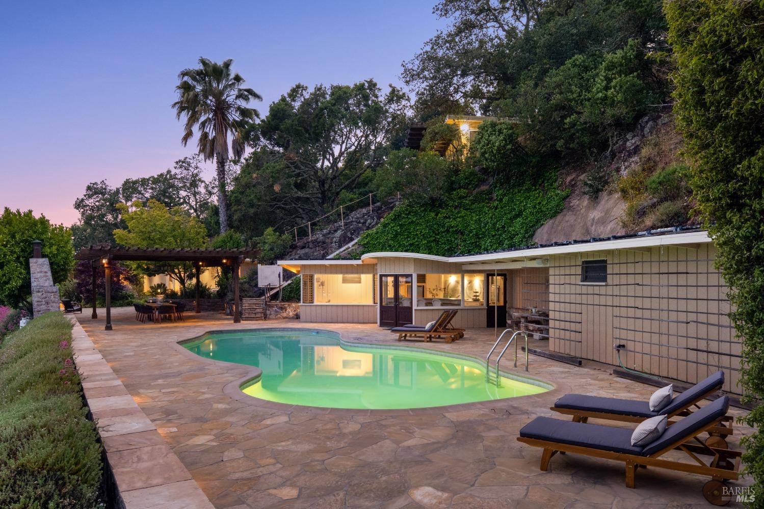a view of a swimming pool with chairs