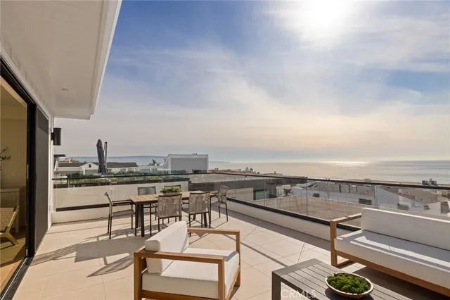 an outdoor sitting area with furniture and a kitchen view