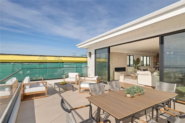 a living room with furniture a flat screen tv and a floor to ceiling window