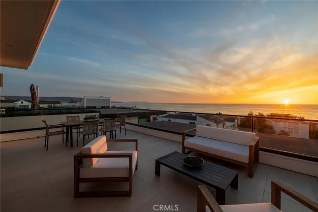 a living room with furniture floor to ceiling window and a flat screen tv