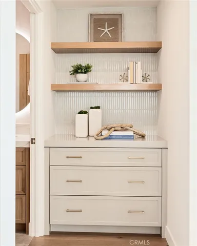 a view of a livingroom with furniture and mirror