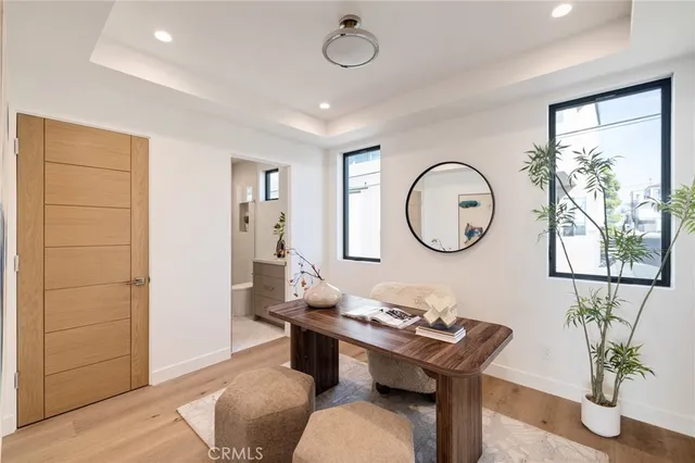 a living room with furniture a mirror and a window