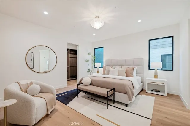 a bedroom with a bed and a potted plant