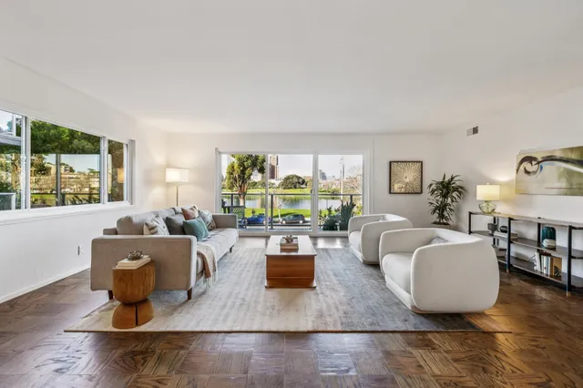 a living room with fireplace furniture and a large window