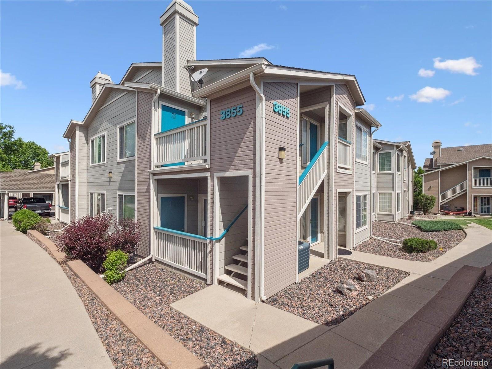 3855 East Canyon Ranch Road, Unit 104 Highlands Ranch, CO 80126 - Photo 1 of 18 a front view of a house with garden