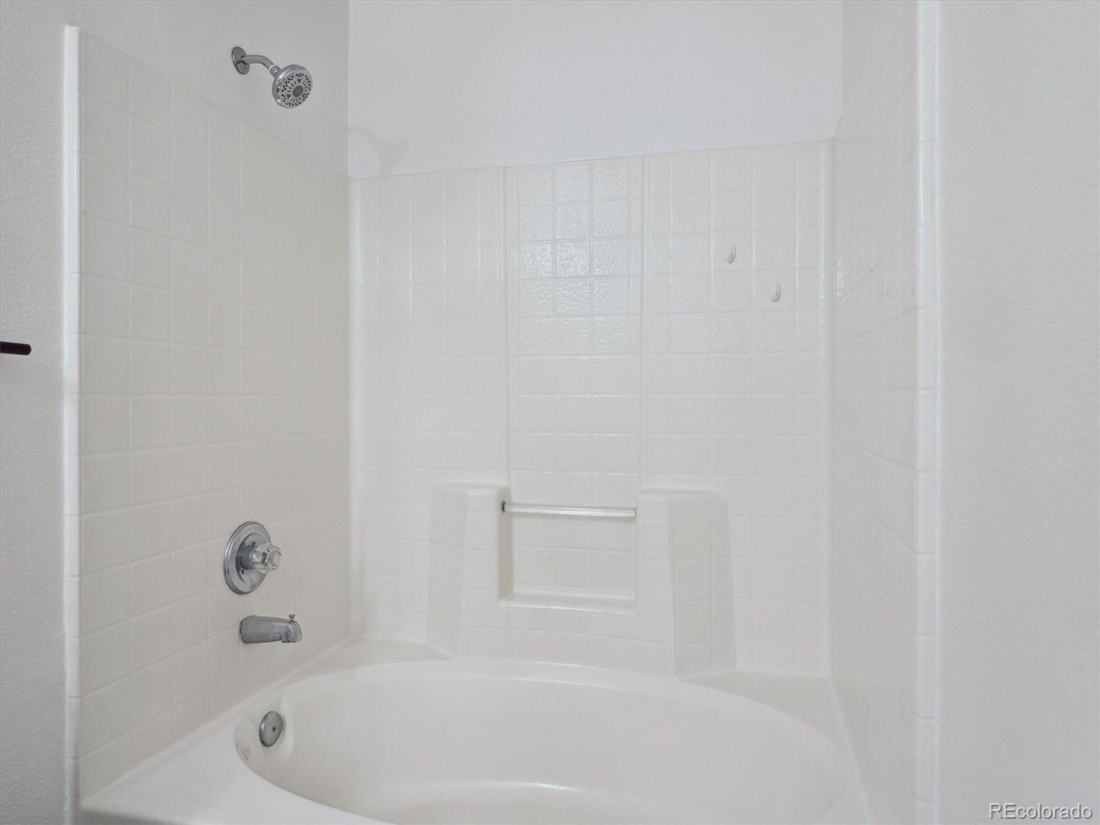 3855 East Canyon Ranch Road, Unit 104 Highlands Ranch, CO 80126 - Photo 12 of 18 a bathroom with a tub