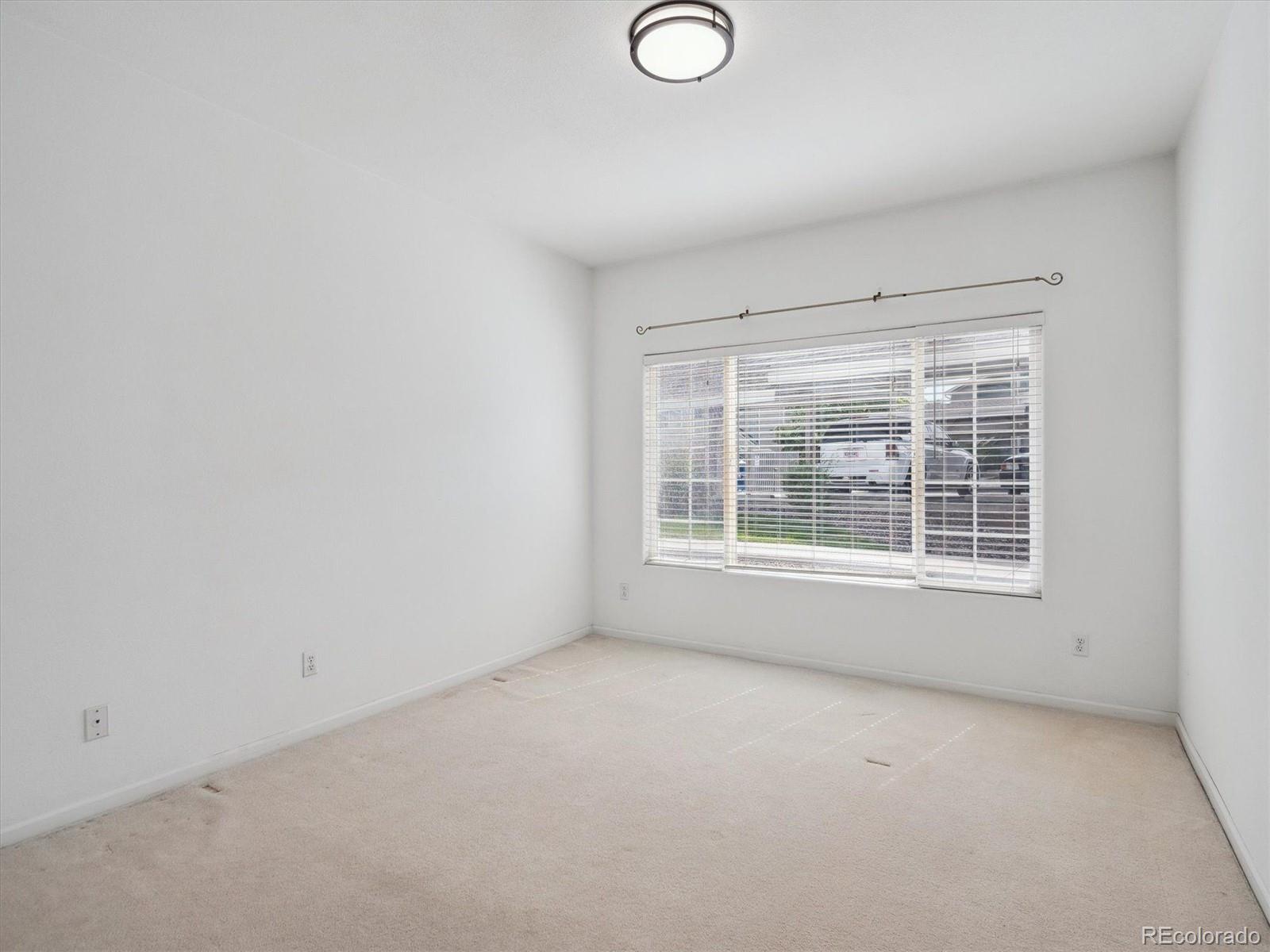 3855 East Canyon Ranch Road, Unit 104 Highlands Ranch, CO 80126 - Photo 8 of 18 a view of an empty room with a window