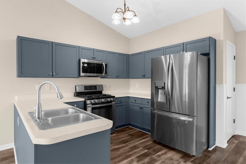 203 Bainbridge Way Dallas, GA 30132 - Photo 11 of 38 a kitchen with stainless steel appliances granite countertop a refrigerator a sink a stove a microwave and wooden cabinets