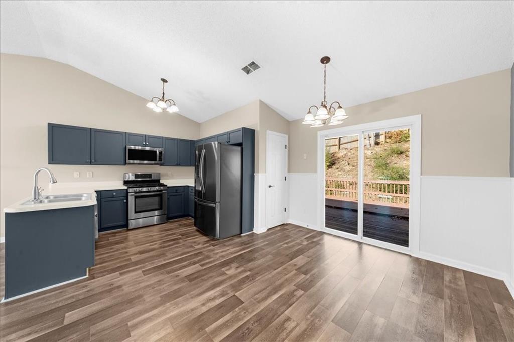 203 Bainbridge Way Dallas, GA 30132 - Photo 14 of 38 a kitchen with stainless steel appliances a refrigerator sink and cabinets