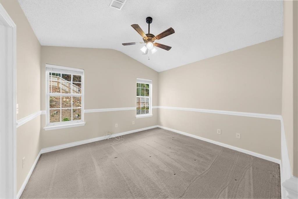 203 Bainbridge Way Dallas, GA 30132 - Photo 18 of 38 an empty room with window and ceiling fan