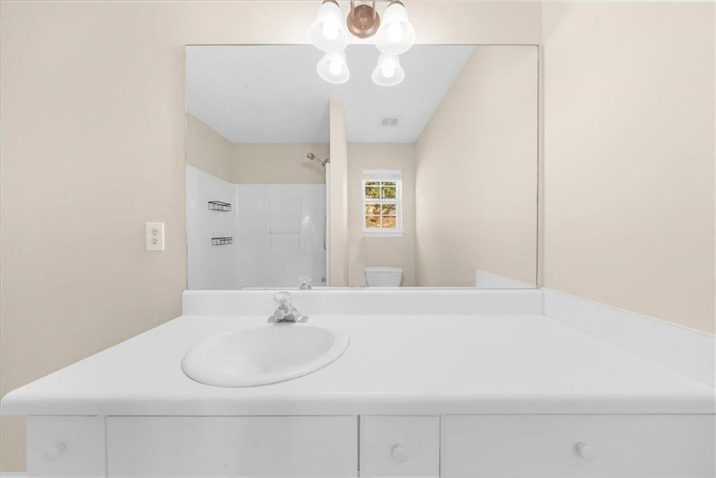 203 Bainbridge Way Dallas, GA 30132 - Photo 22 of 38 a bathroom with a sink and a mirror
