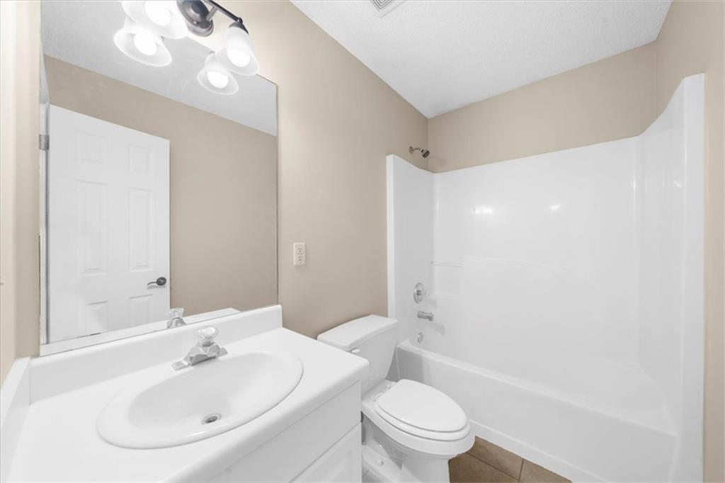 203 Bainbridge Way Dallas, GA 30132 - Photo 26 of 38 a bathroom with a sink a toilet and shower