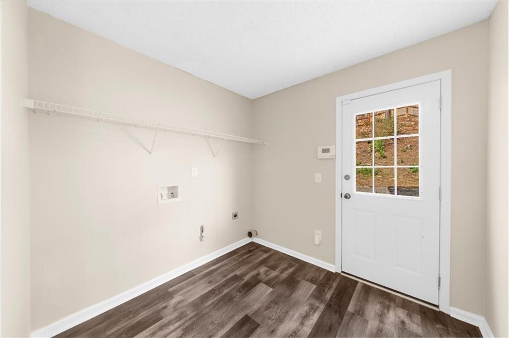 203 Bainbridge Way Dallas, GA 30132 - Photo 28 of 38 a view of an empty room with wooden floor and a window