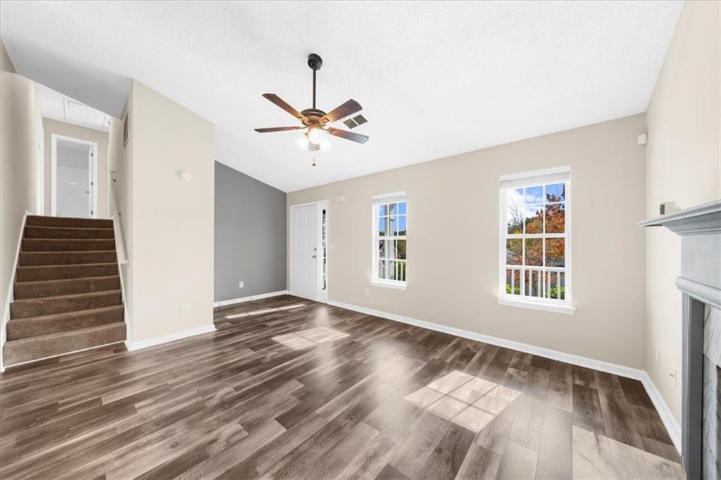 203 Bainbridge Way Dallas, GA 30132 - Photo 6 of 38 a view of an empty room with wooden floor and a window