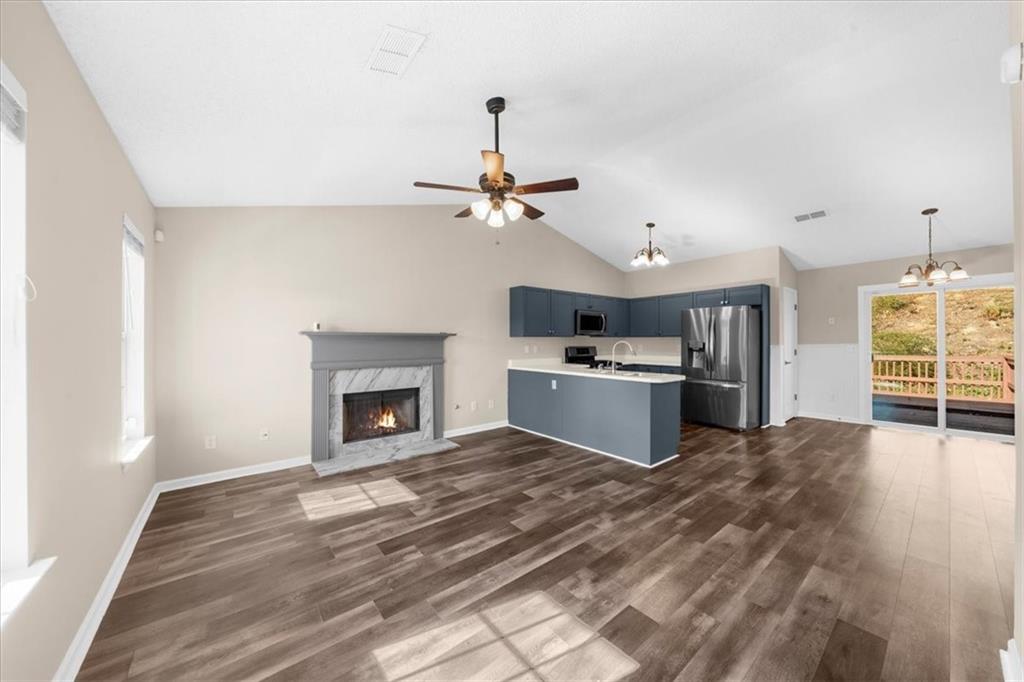 203 Bainbridge Way Dallas, GA 30132 - Photo 7 of 38 a view of a kitchen with a sink and a fireplace