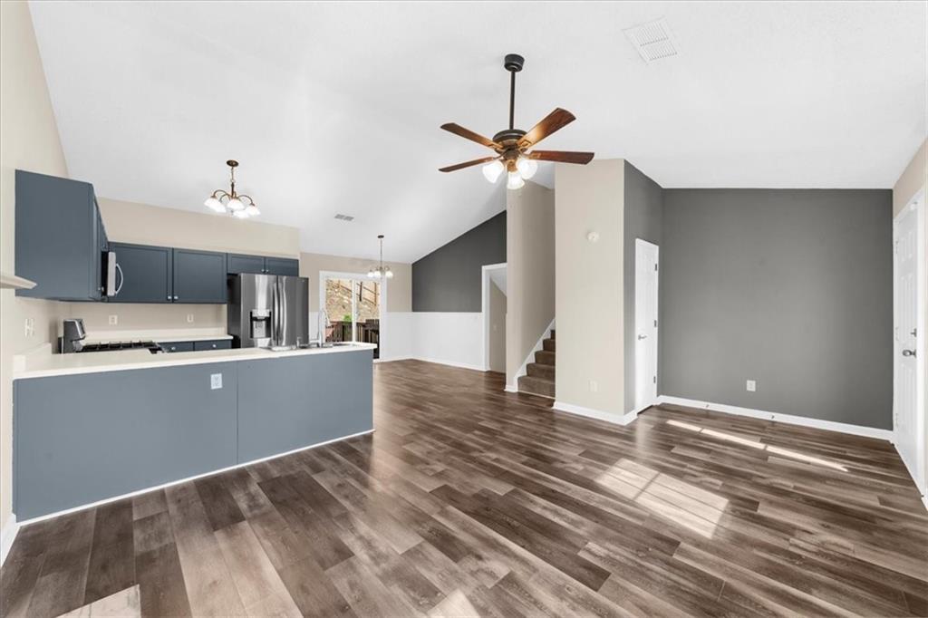 203 Bainbridge Way Dallas, GA 30132 - Photo 8 of 38 a view of a kitchen with wooden floor and a ceiling fan