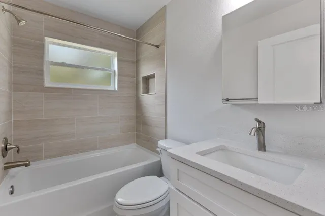 a bathroom with a sink a toilet and bathtub