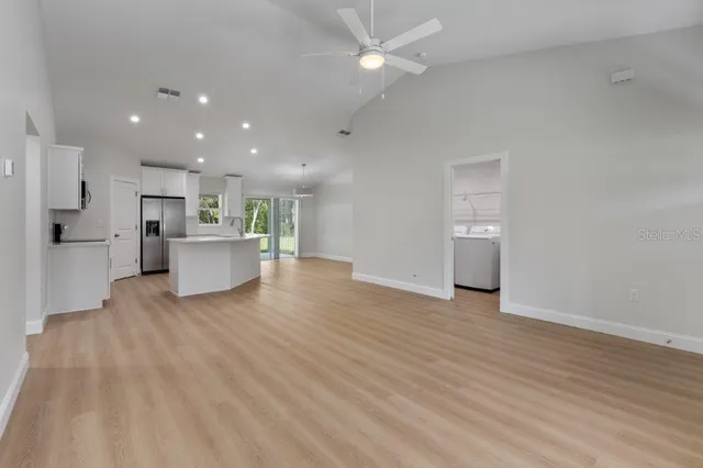 a view of a kitchen with a sink and a refrigerator