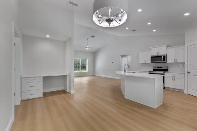 a view of kitchen with cabinets and wooden floor