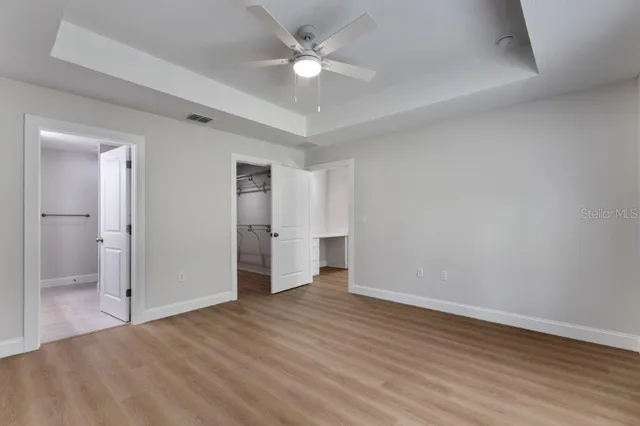 wooden floor in an empty room with a bathroom