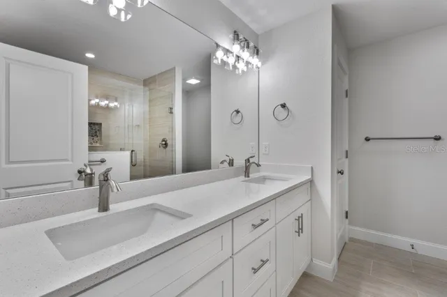 a bathroom with a sink double vanity and a mirror