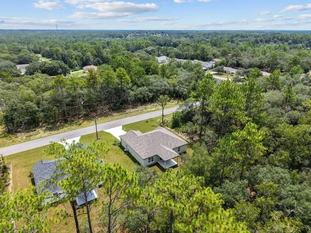 a view of a back yard with a lake view