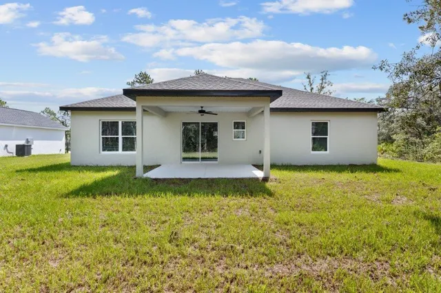 a view of a house with pool and a garden
