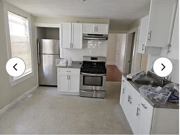 a kitchen with stainless steel appliances granite countertop a stove a refrigerator and a refrigerator
