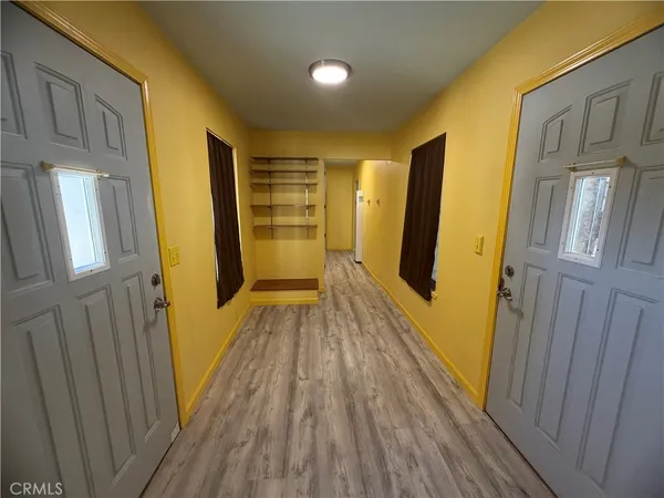 a view of hallway with wooden floor