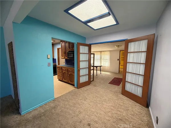 an empty room with windows and closet