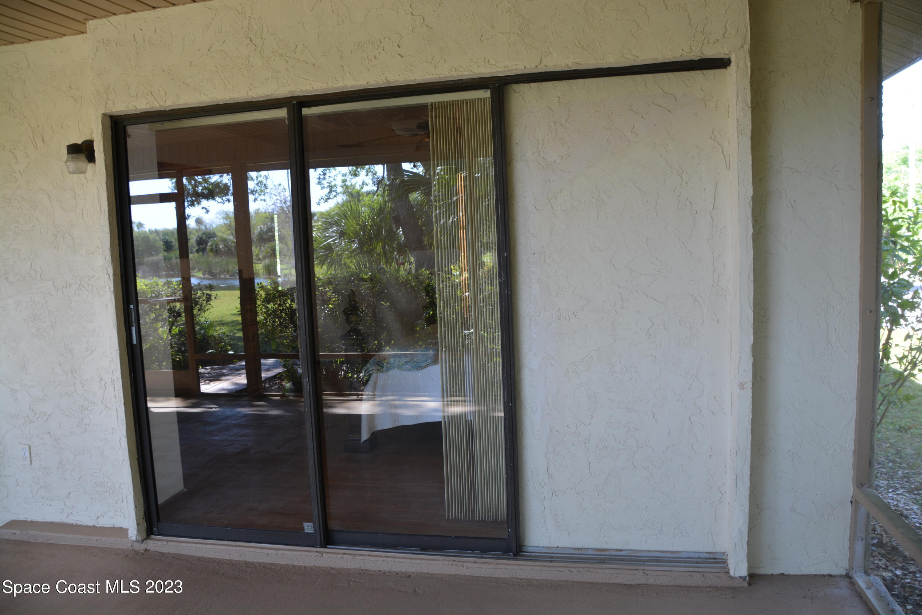 1045 Pine Island Road Merritt Island, FL 32953 - Photo 21 of 42 a room with large glass door