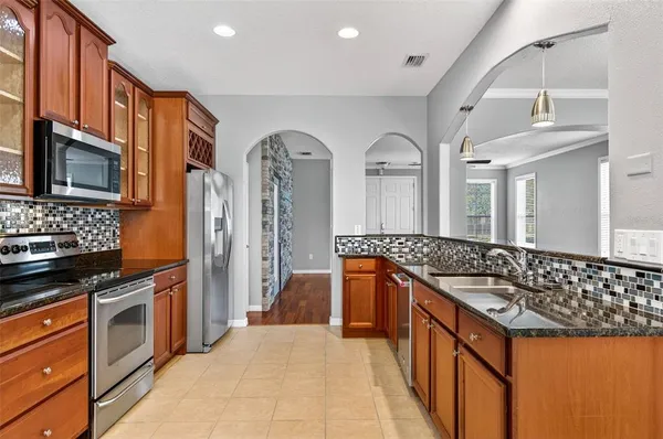 a kitchen with stainless steel appliances granite countertop a stove and a sink