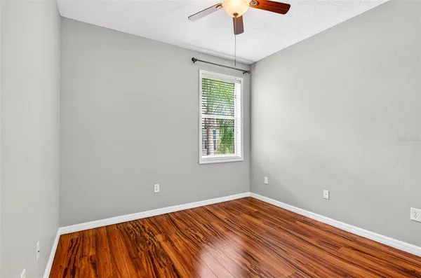 a view of an empty room with wooden floor