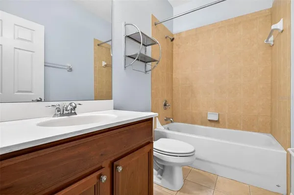 a view of a livingroom with a ceiling fan and window