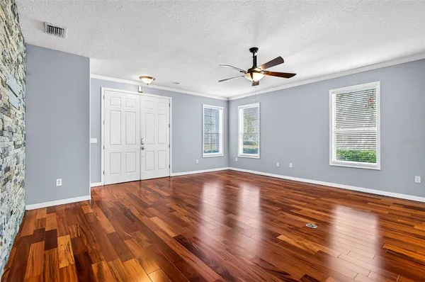 a view of empty room with wooden floor and window