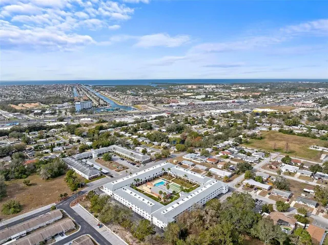 an aerial view of residential building with yard