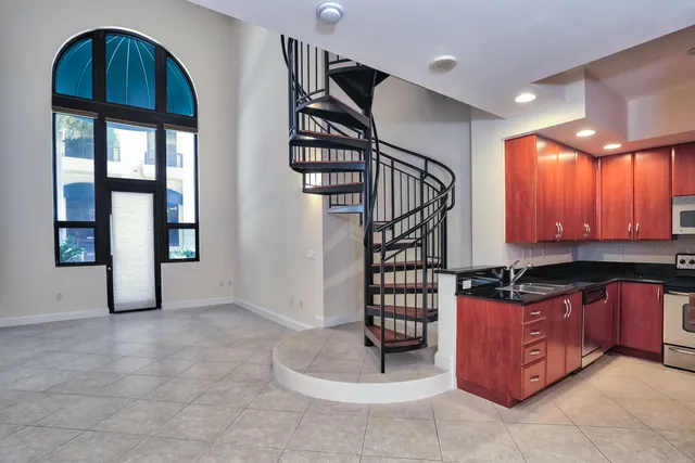 a view of a kitchen with furniture and staircase