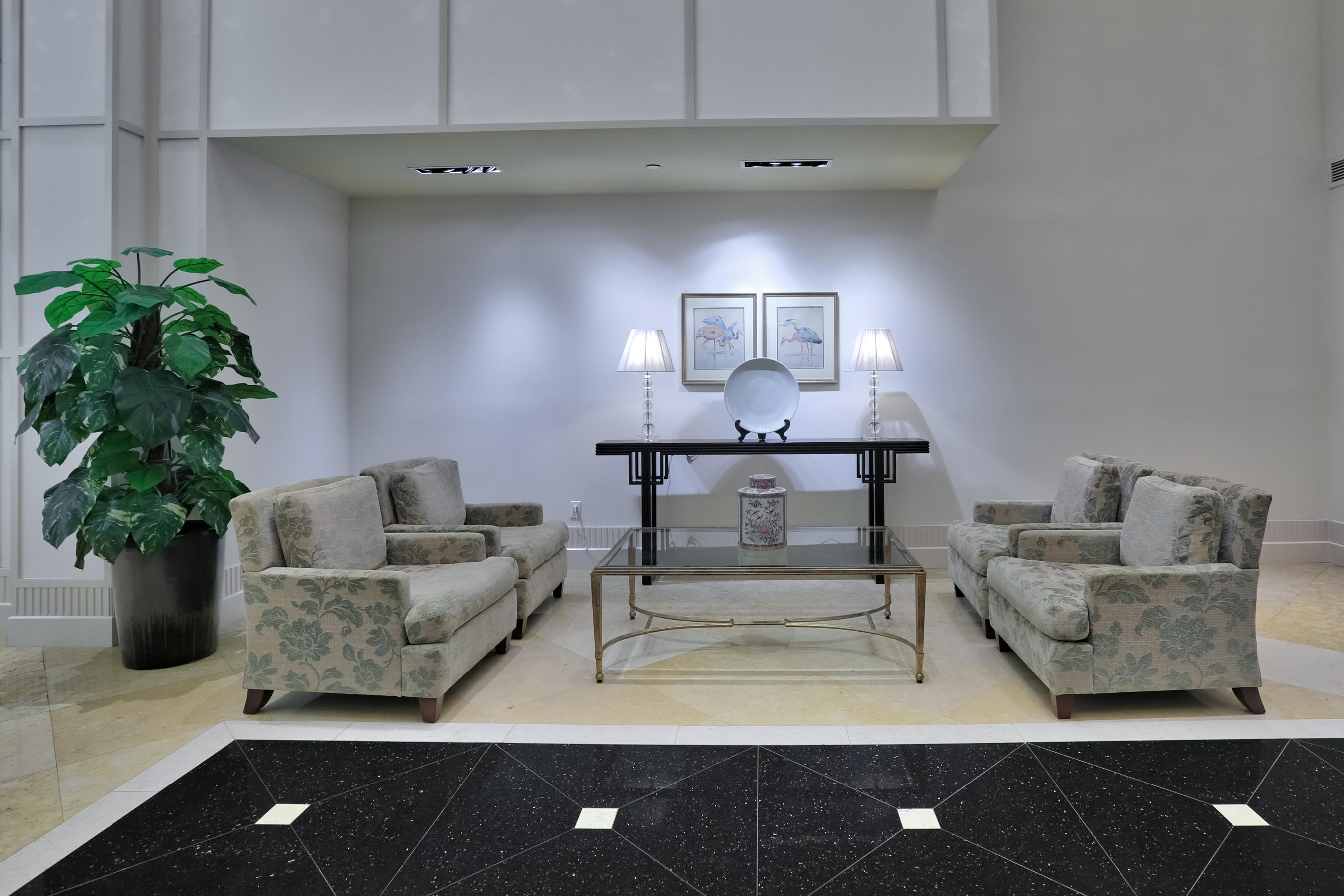 801 South Olive Avenue, Unit 120 West Palm Beach, FL 33401 - Photo 14 of 17 a living room with furniture and a lamp