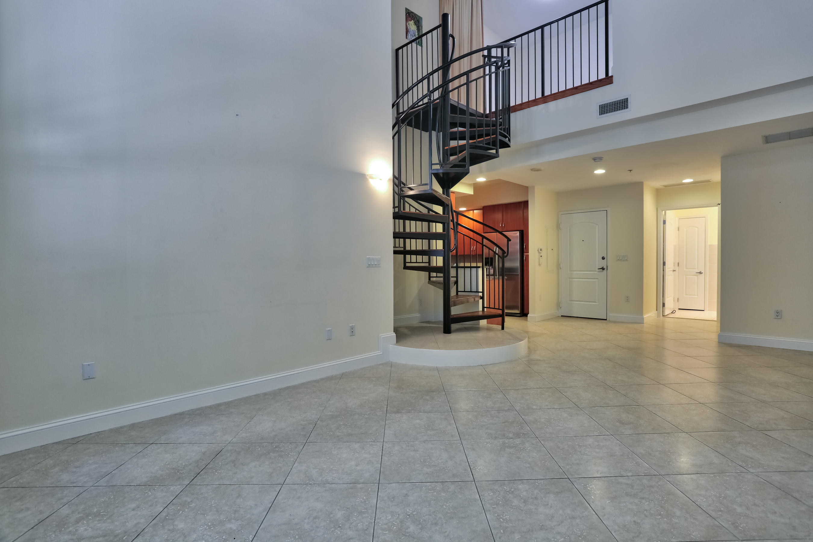 801 South Olive Avenue, Unit 120 West Palm Beach, FL 33401 - Photo 3 of 17 a view of a hallway with stairs