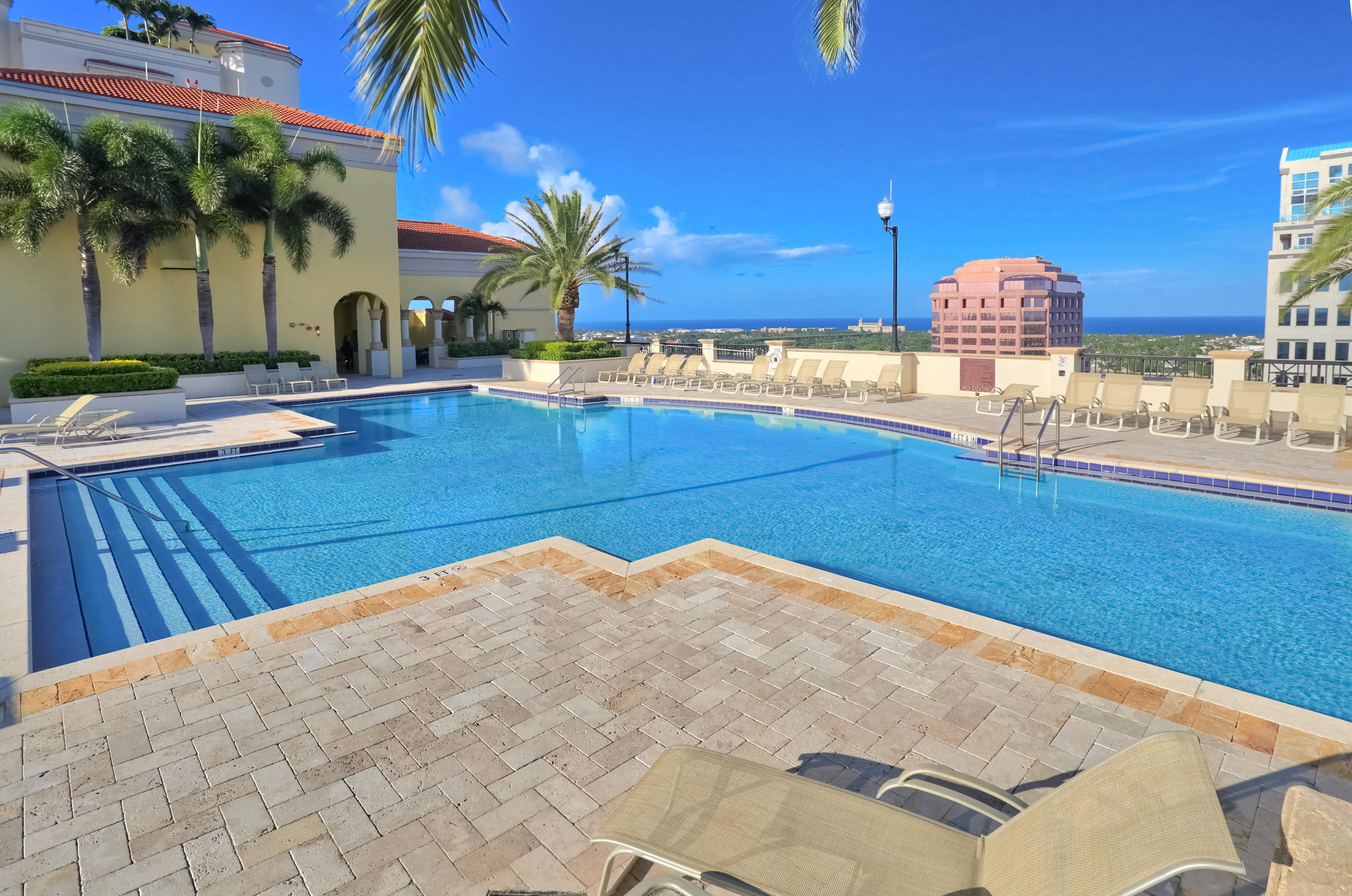 801 South Olive Avenue, Unit 120 West Palm Beach, FL 33401 - Photo 7 of 17 a view of a swimming pool with a table and chairs