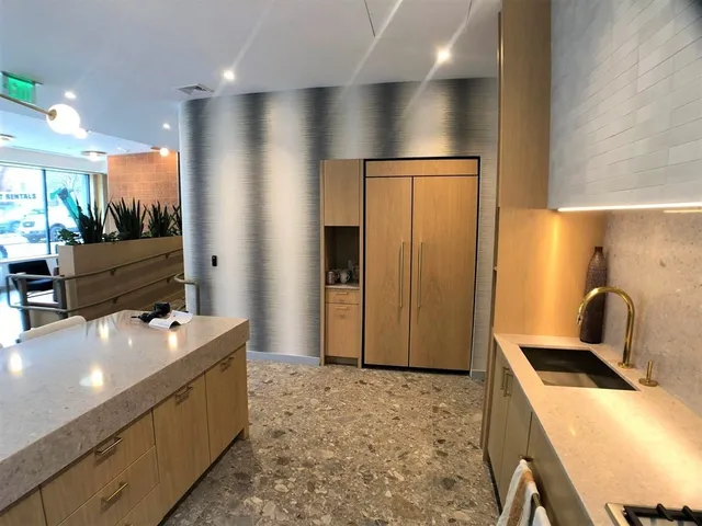 a room with pool table a couch and a stove top oven