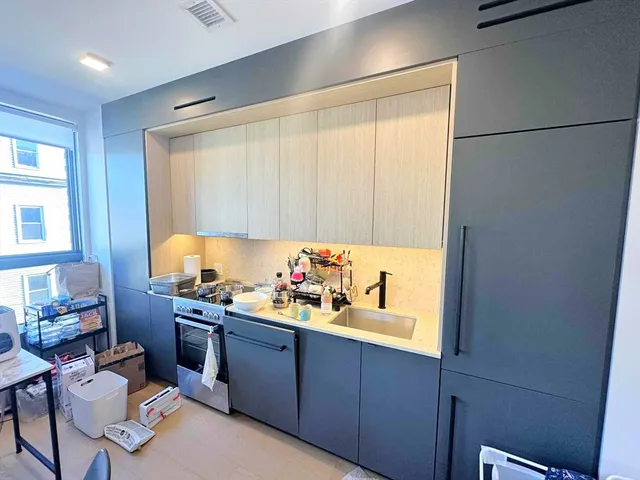 a kitchen with a sink cabinets and appliances